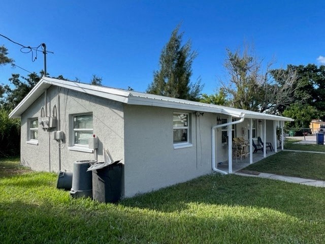 a small white house with a yard and grass
