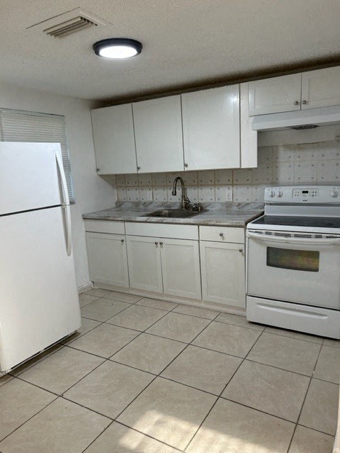 a kitchen with a stove and a refrigerator