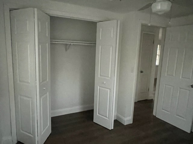 an empty room with white doors and a wood floor