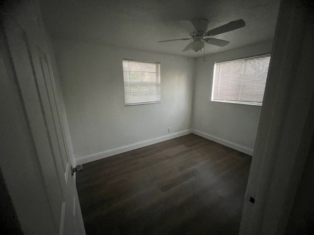a room with wood floors and a ceiling fan