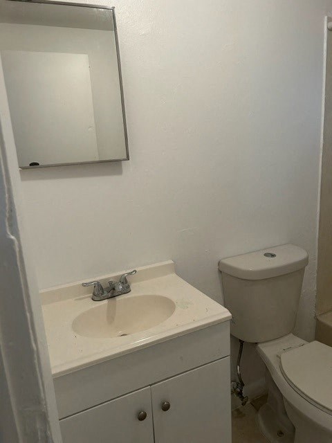 a bathroom with a sink and a toilet and a mirror