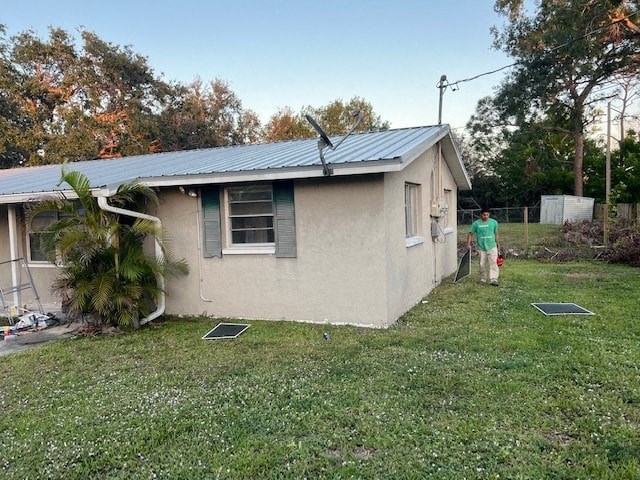 a person is standing outside of a small house