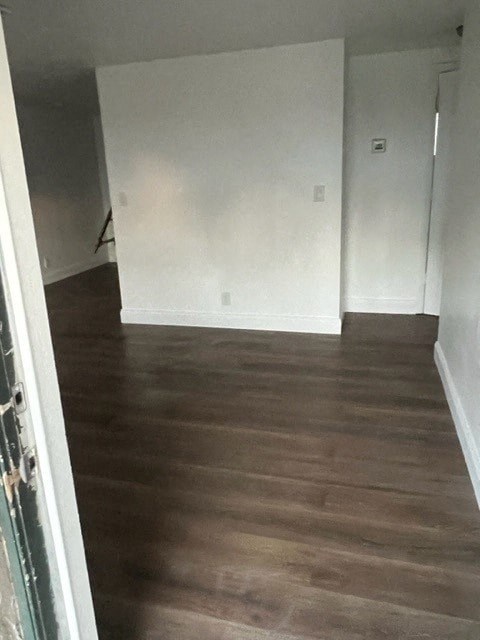 a empty room with a wooden floor and white walls