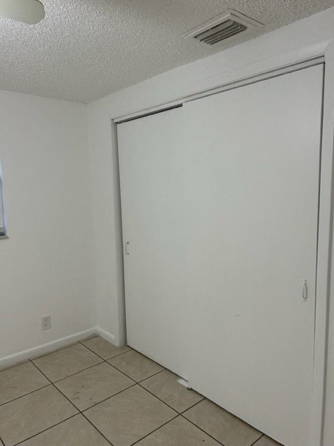 an empty room with a white wall and a sliding door