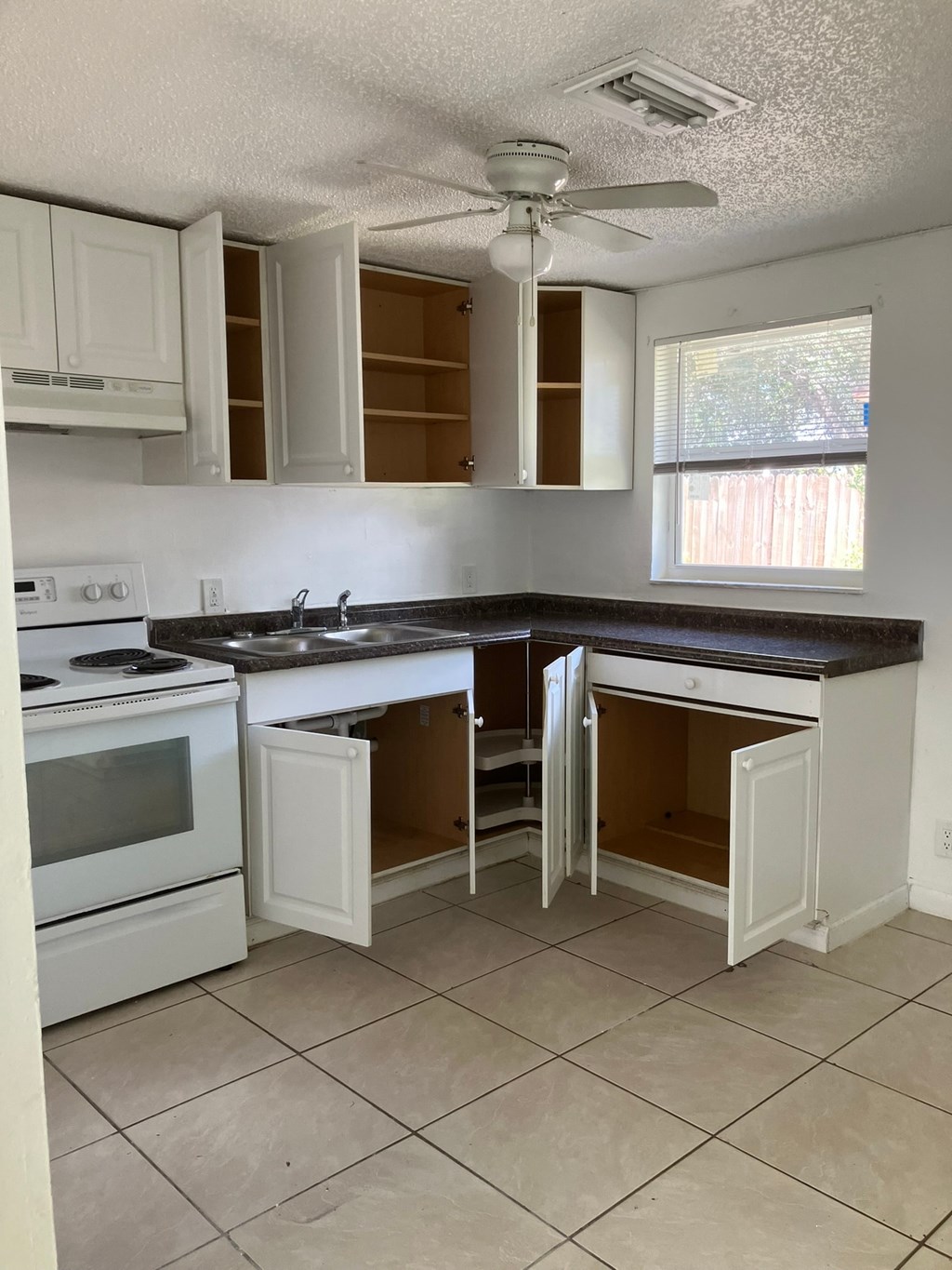 a kitchen with white cabinets and a counter top