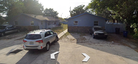 a car parked in a driveway in front of a house