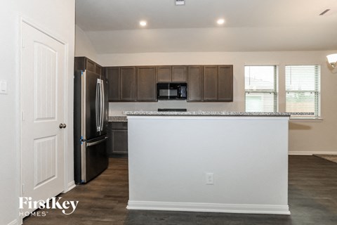 a kitchen with a counter top and a refrigerator