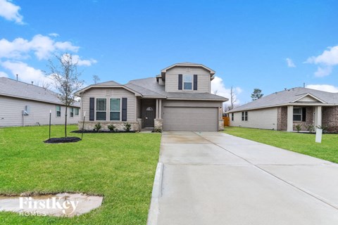 a suburban house with a driveway and a lawn