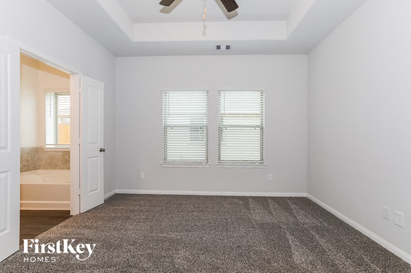 a bedroom with a carpeted floor and white walls