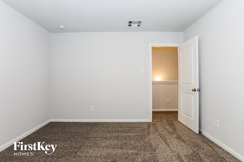 a bedroom with a carpeted floor and white walls