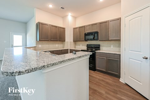 a kitchen with granite counter tops and stainless steel appliances