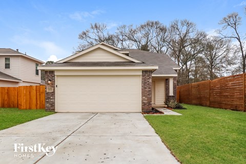 A house with a garage is for sale by FirstKey Homes.