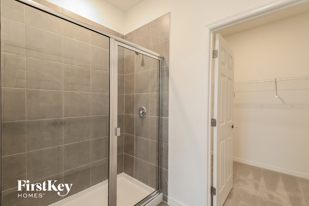 a bathroom with a shower and a door in it