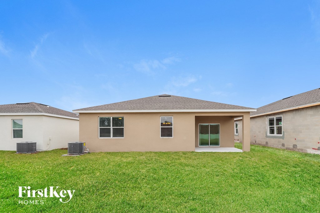 a home with a green lawn and a blue sky