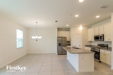 a kitchen with white cabinets and a granite counter top