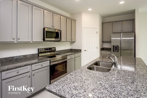 a kitchen with granite counter tops and stainless steel appliances