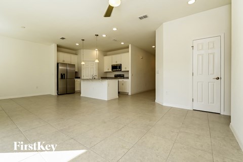 an open kitchen and living room with a large tile floor