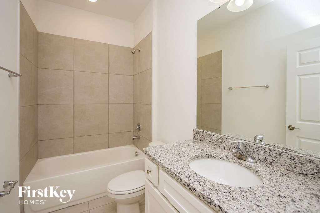 a bathroom with a sink and a tub and a toilet