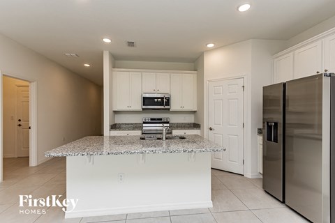 A kitchen with granite countertops and stainless steel appliances.