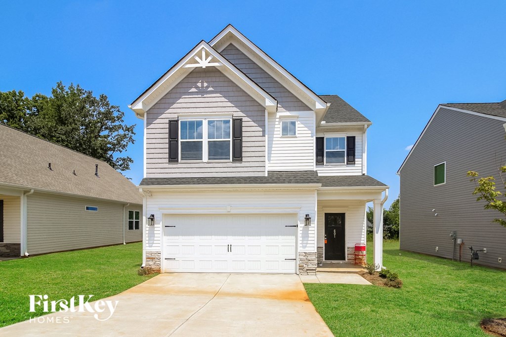 A two-story house with a garage is for sale by FirstKey Homes.