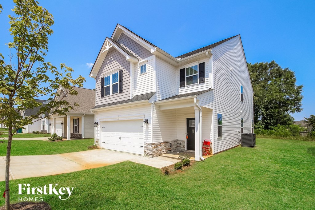 A two-story house with a garage is for sale by FirstKey Homes.