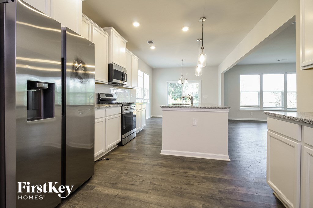 A kitchen with a refrigerator and a countertop.