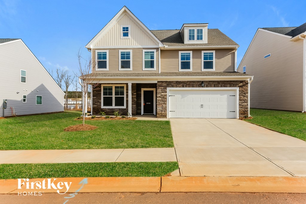 A two-story house with a garage is for sale by FirstKey Homes.