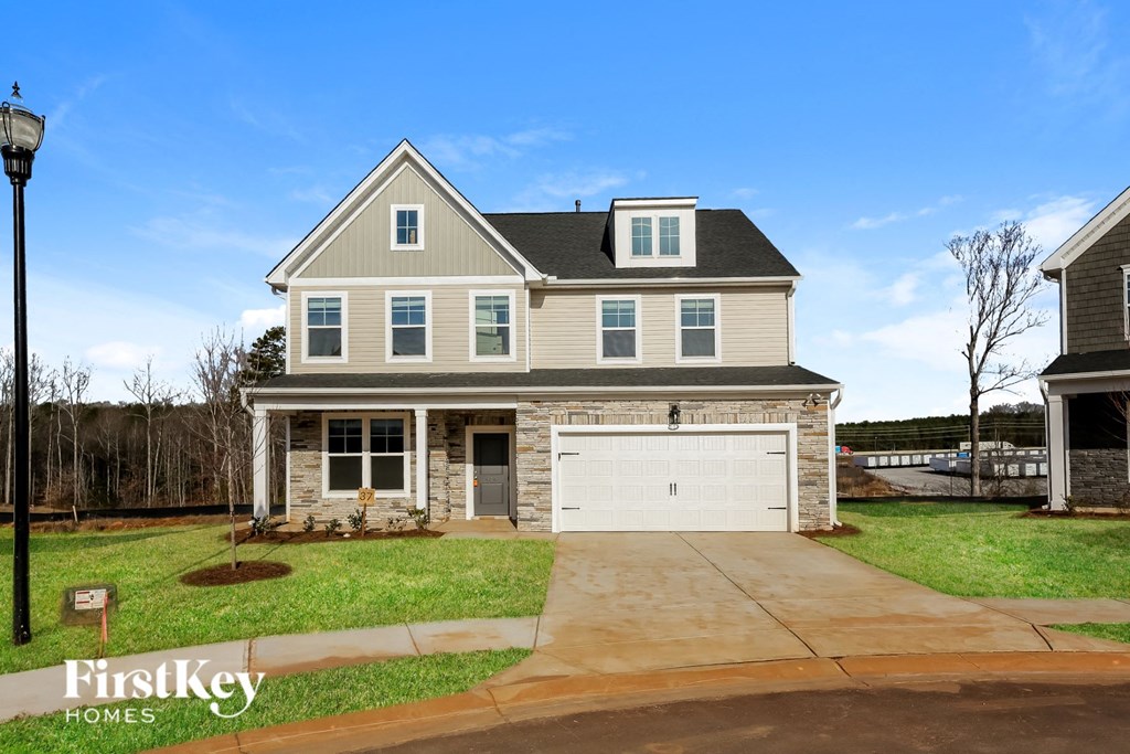 A two-story house with a garage is for sale.