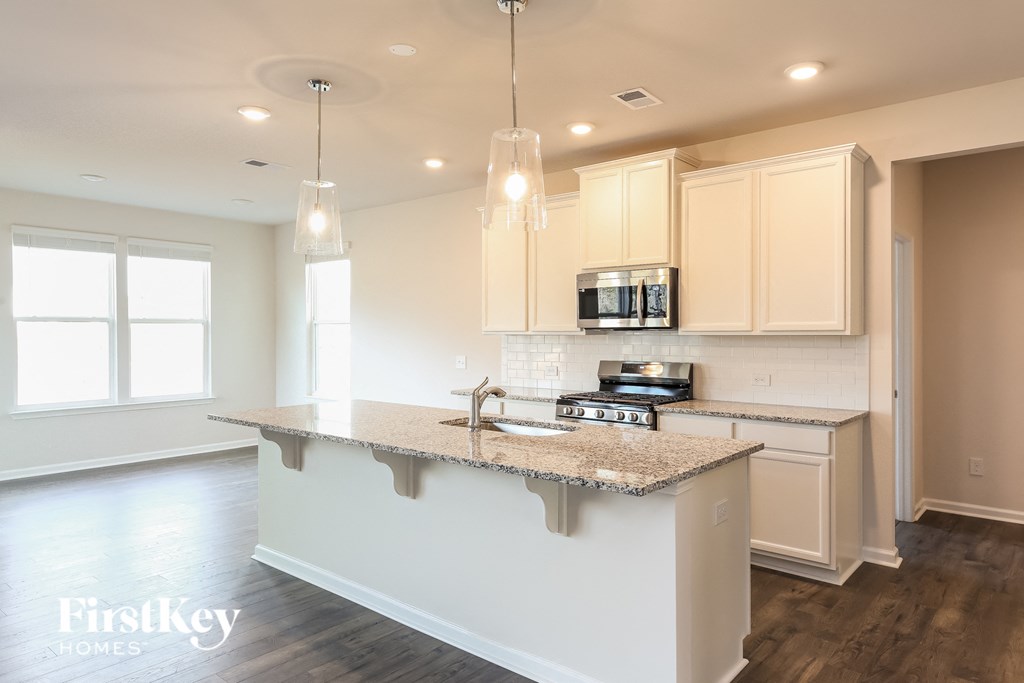 A kitchen with a granite countertop and a sink.