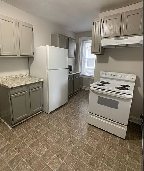 a kitchen with a stove and a refrigerator
