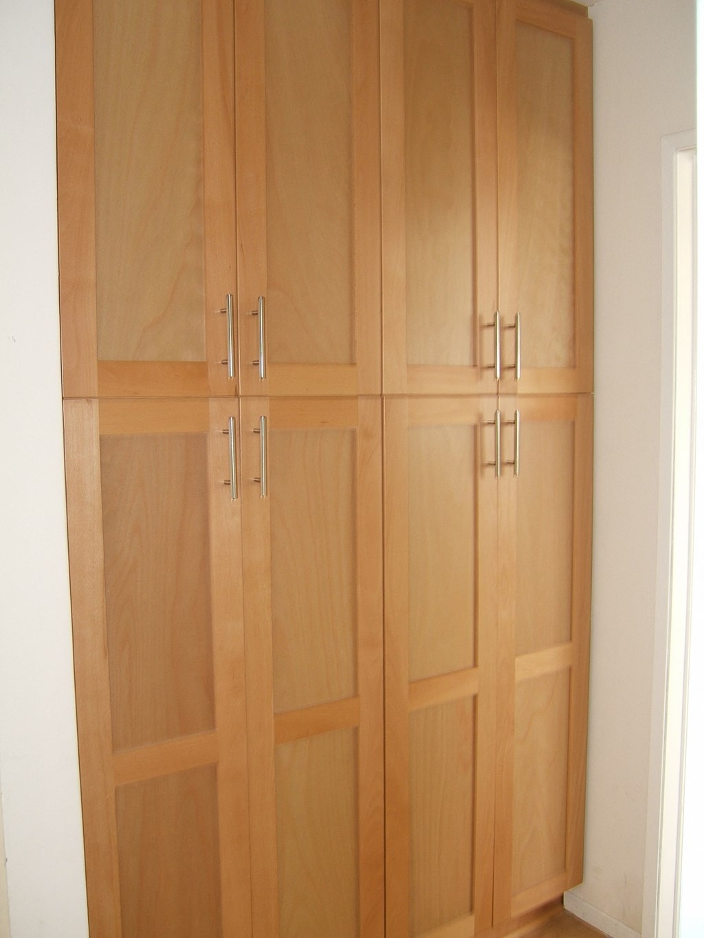 A set of four wooden doors with handles.