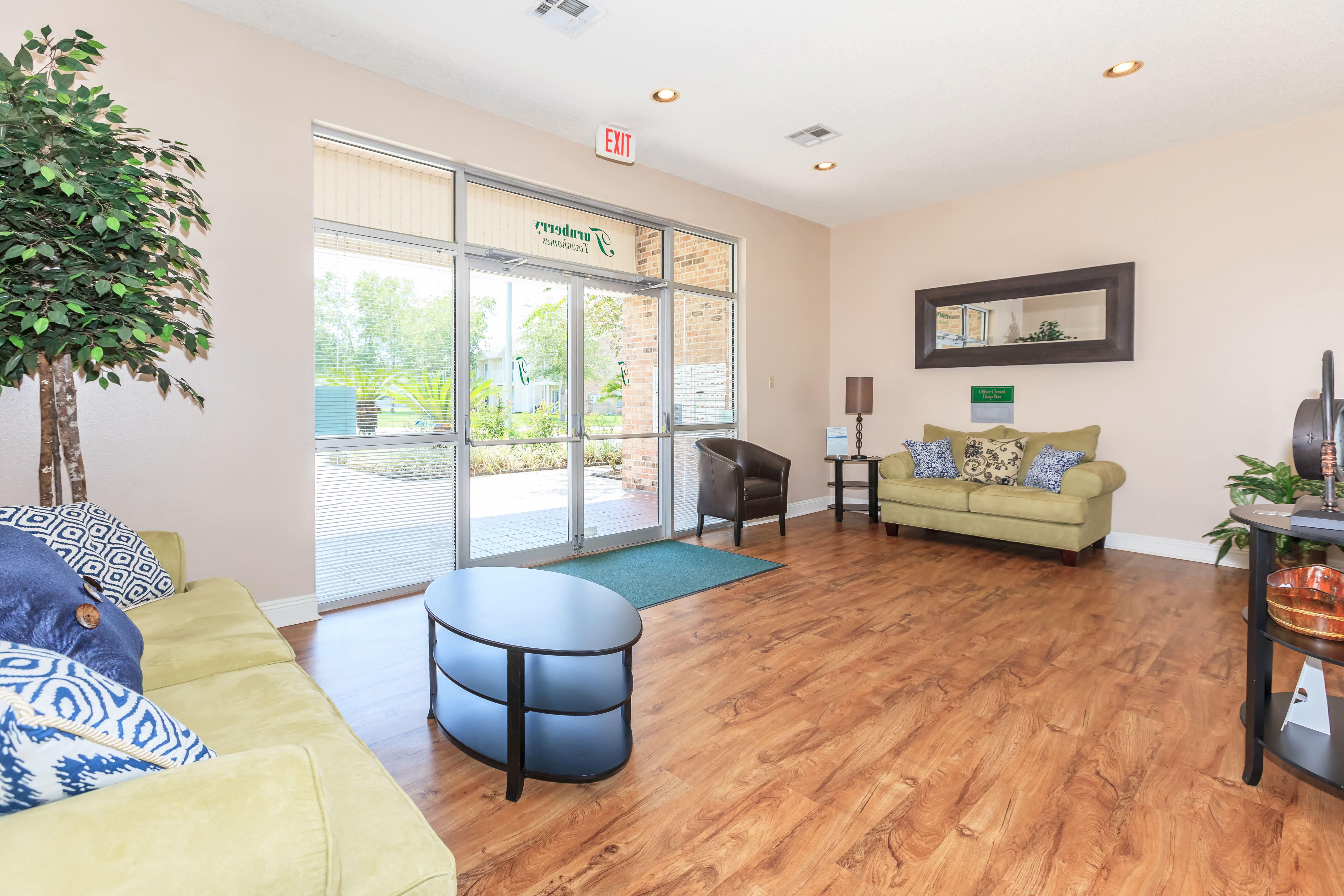 a living room with furniture and sliding glass doors to a pool