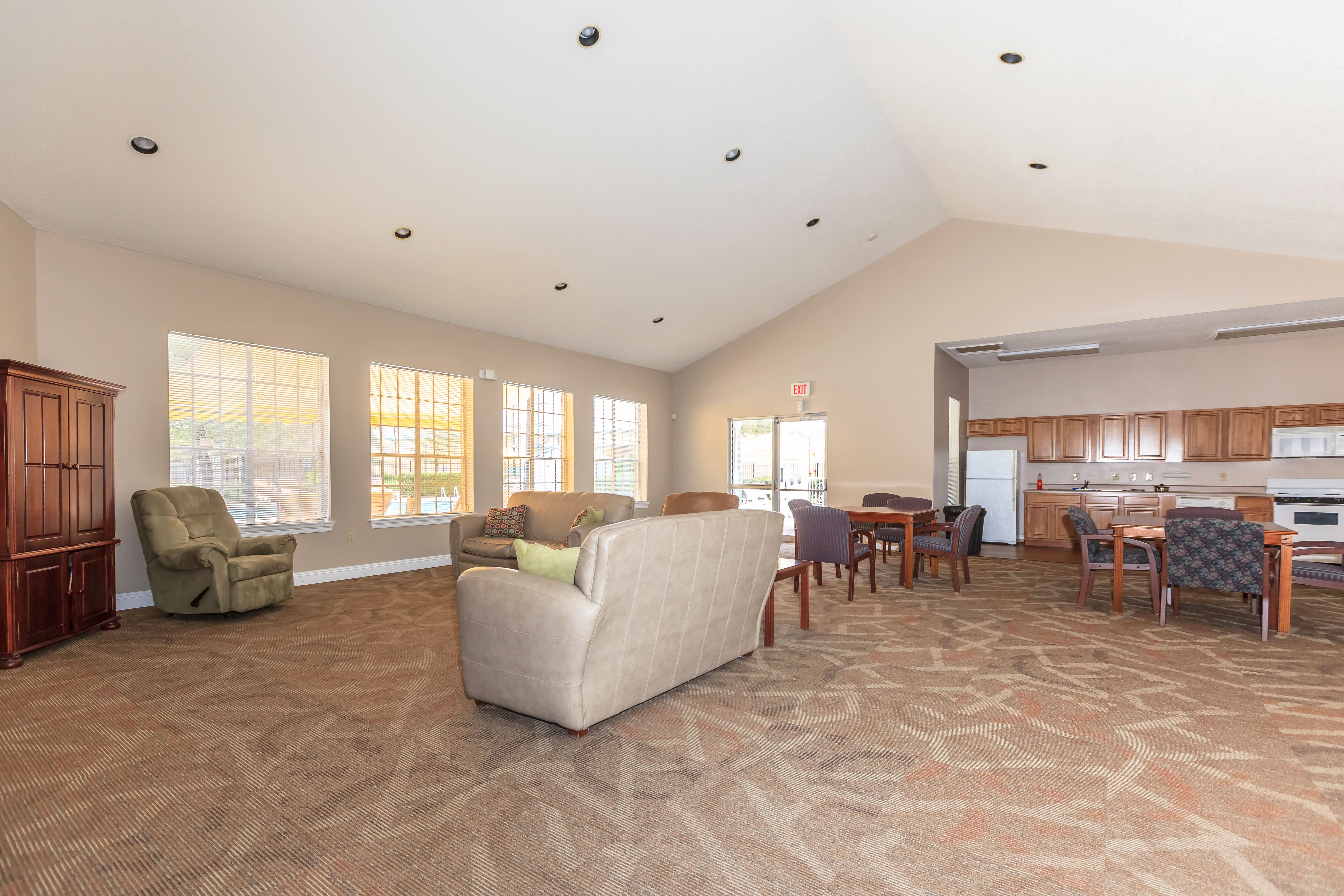 a living room with a couch and a kitchen with a table and chairs