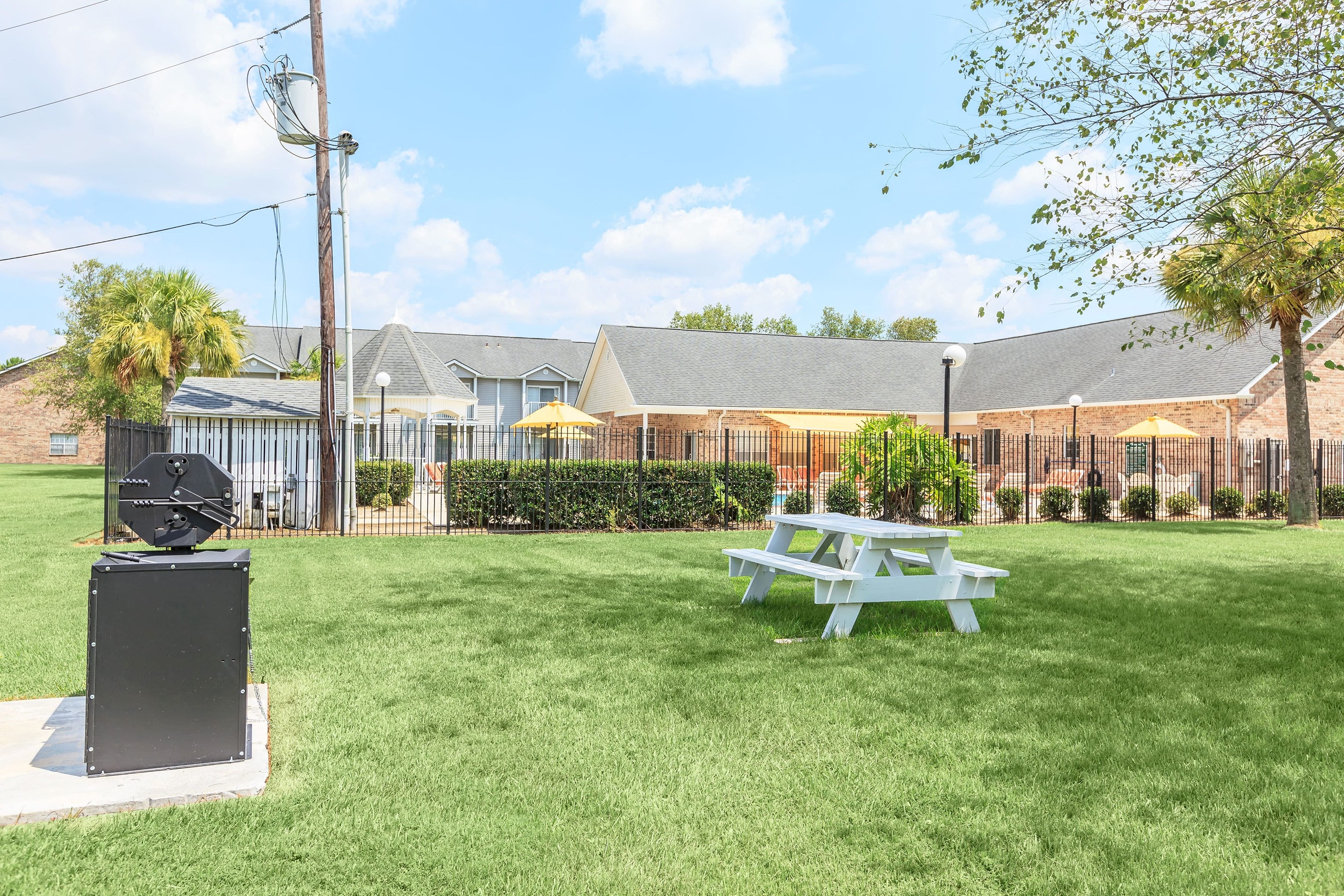 our yard has a picnic table and a grill in front of our building