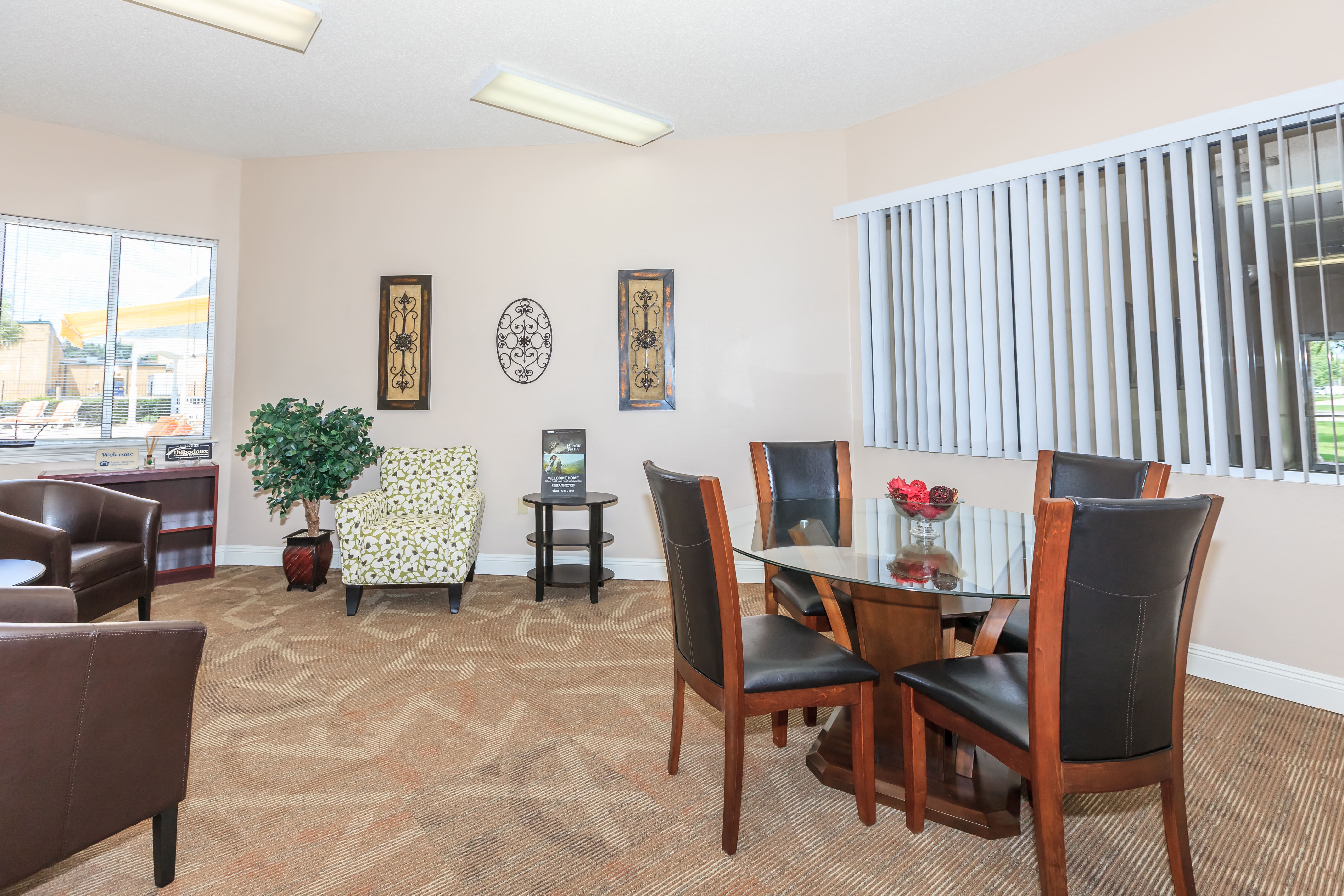 a dining room with a table and chairs and a window