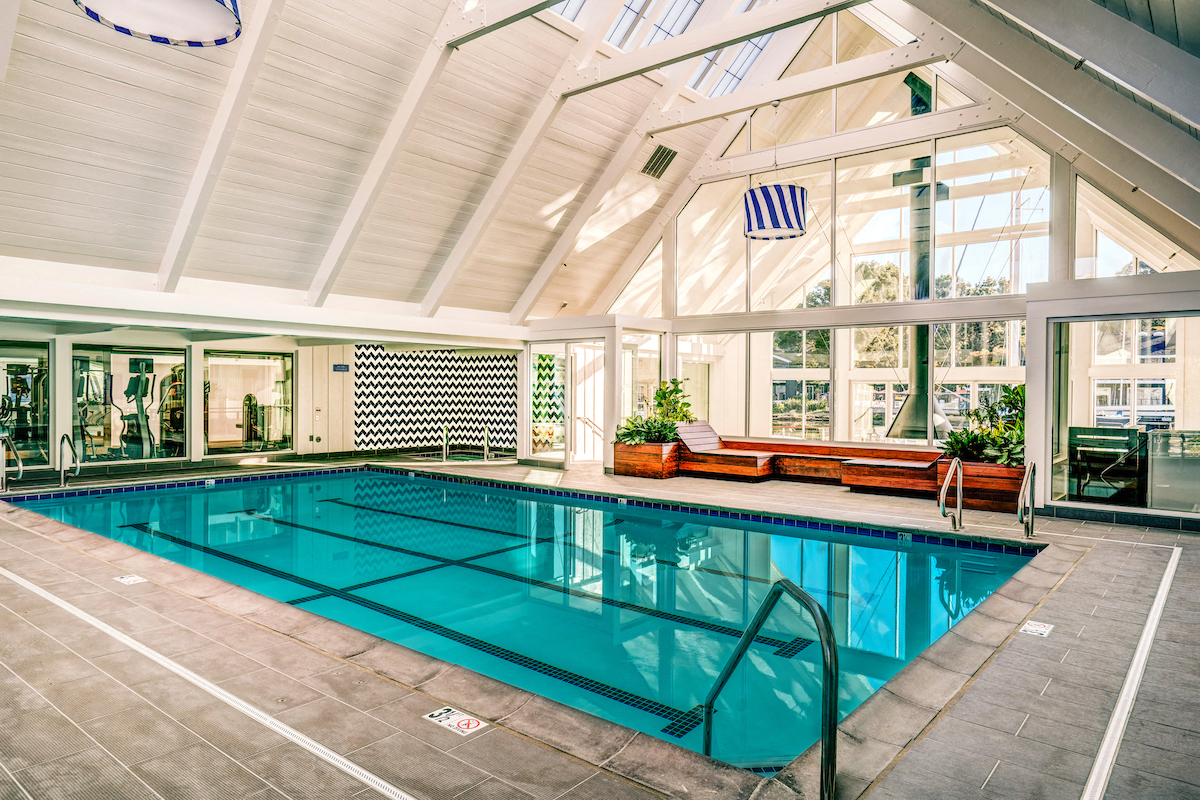 a swimming pool in a building with a large windowed pool