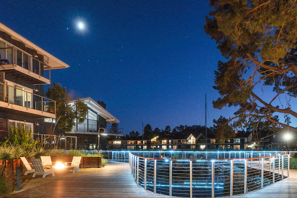 a pool is lit up at night at a resort