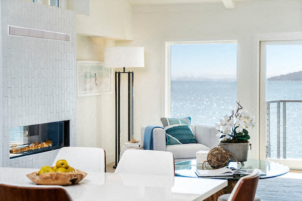 a living room with a fireplace and a table and chairs