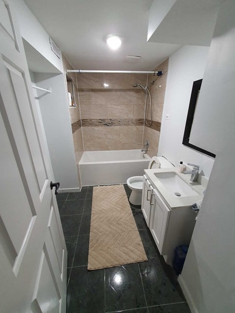 a small bathroom with a toilet sink and bath tub
