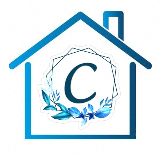 a house with a letter c in it and flowers