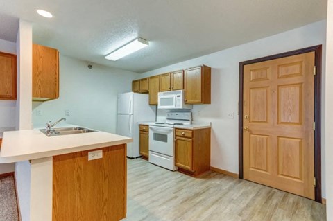 A kitchen with wooden cabinets and a white countertop.