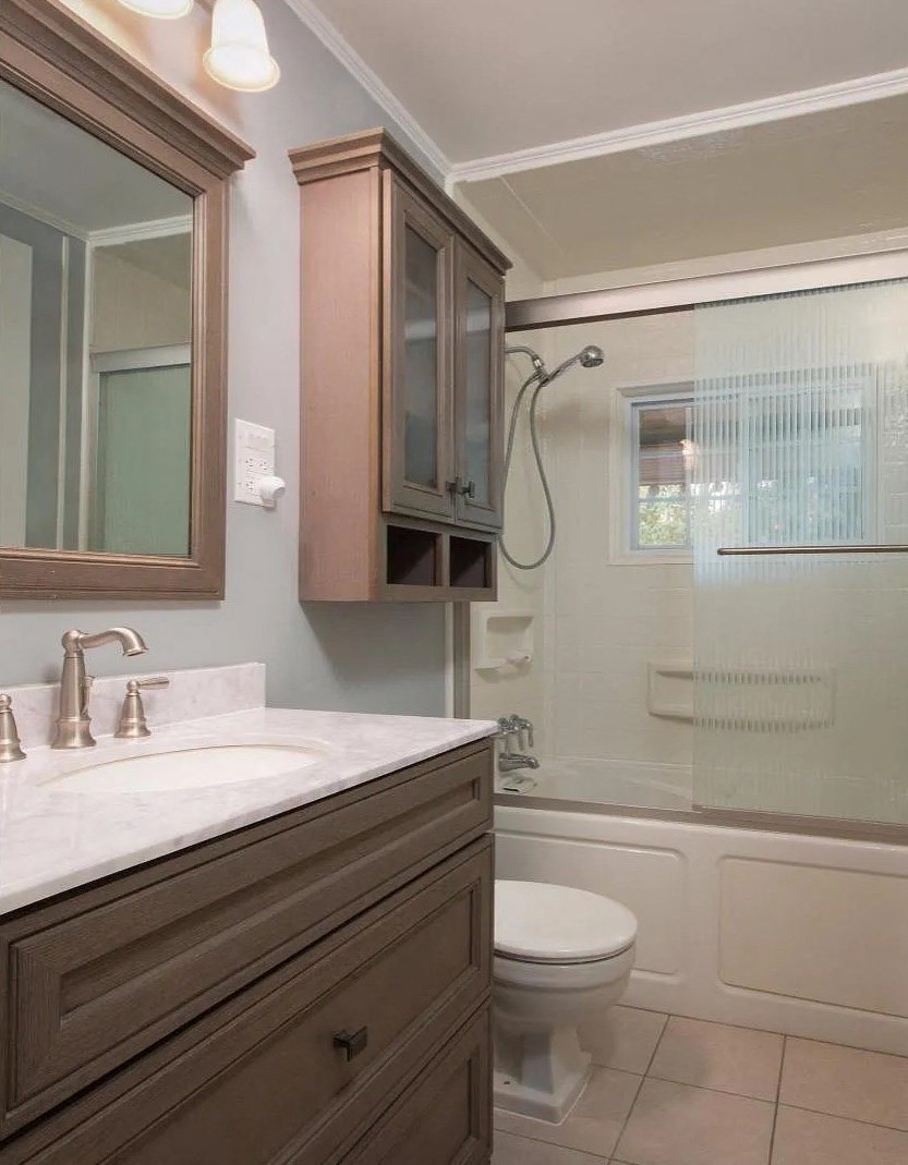 a bathroom with a toilet and a sink and a shower