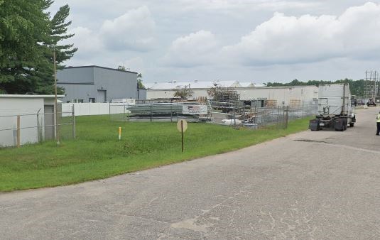 a road with a tractor parked in front of a building