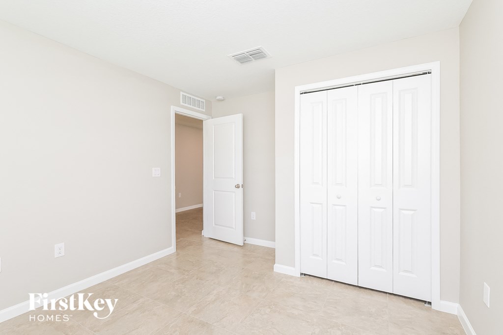 a bedroom with two closets and a door to a hallway