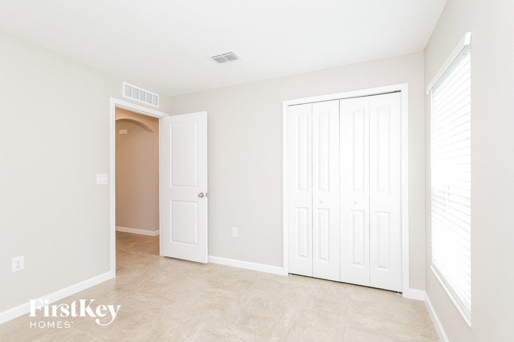 a bedroom with two closets and a door to a hallway