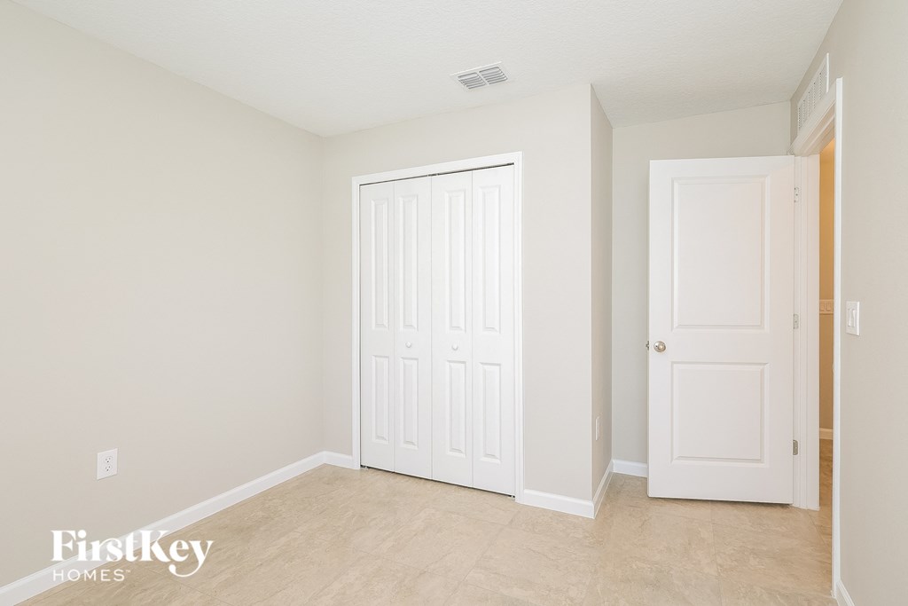 a bedroom with two closets and a white door
