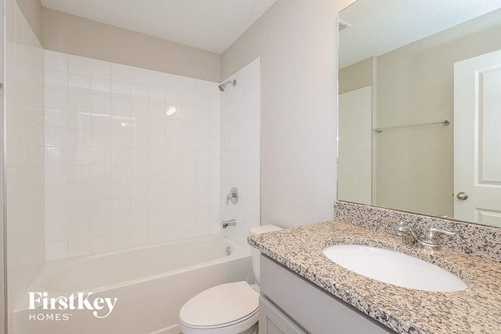 a bathroom with a sink and a tub and a toilet