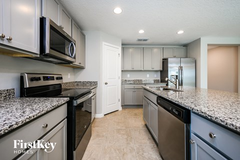 a kitchen with granite counter tops and stainless steel appliances