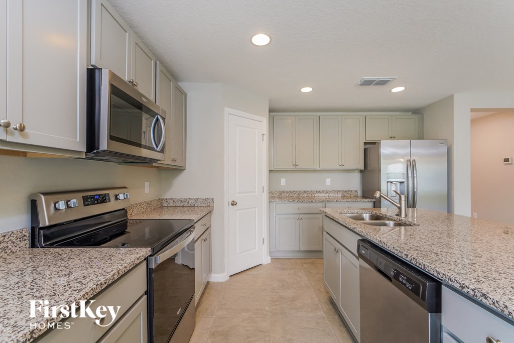 a kitchen with granite counter tops and stainless steel appliances
