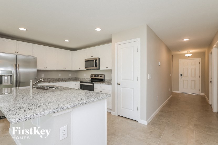 a kitchen with white cabinets and a counter top